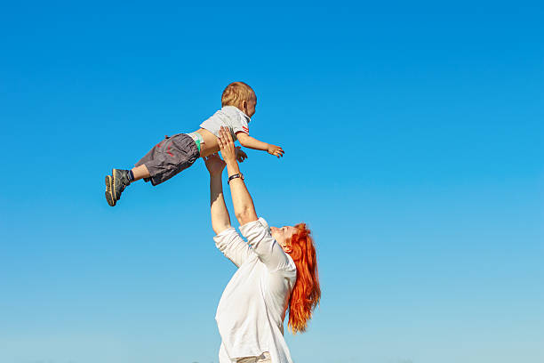 istock Beautiful red-haired mother playing with her baby. 543178348