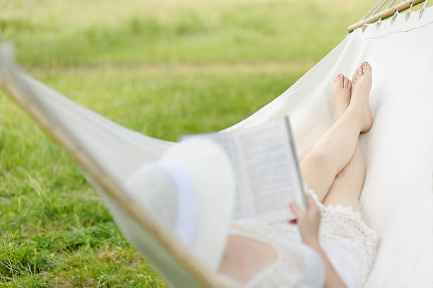 istock Woman resting in hammock outdoors. 543178960