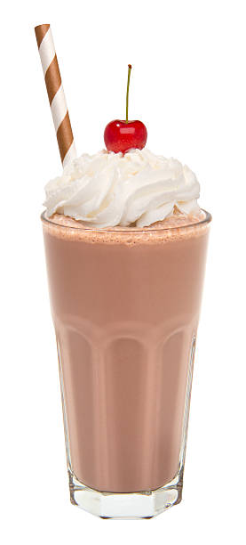 vanilla chocolate milkshake with whipped cream and cherry isolated stock photo