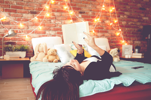 Cute female enjoy at home reading a book