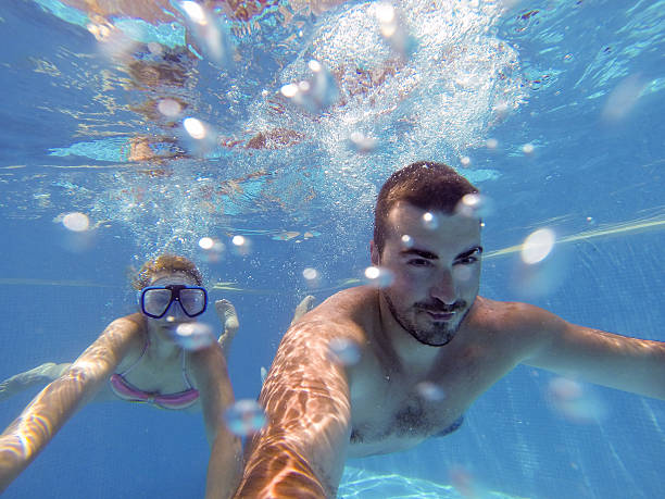 istock Couple having fun under the water 543179552