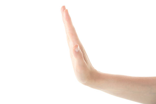 istock Female Hand is Making Stop Gesture Against Isolated White Backgr 543180454
