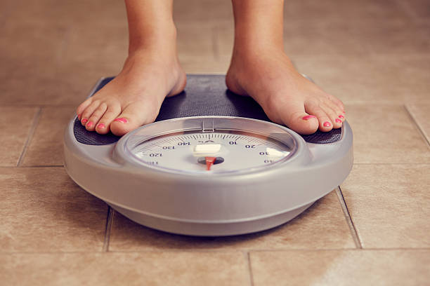 istock Female feet on a bathroom scale 543180650