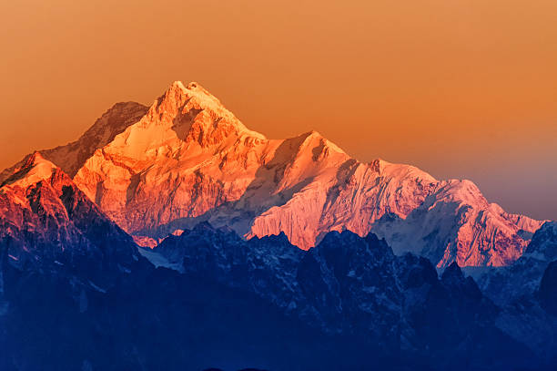 Sunrise on Mount Kanchenjugha, at Dawn, Sikkim Beautiful first light from sunrise on Mount Kanchenjugha, Himalayan mountain range, Sikkim, India. Orange tint on the mountains at dawn mountain peak stock pictures, royalty-free photos & images