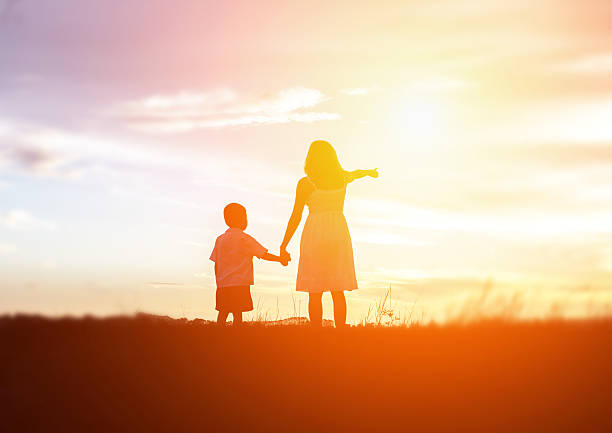 istock Mother encouraged her son outdoors at sunset, silhouette concept 543183492