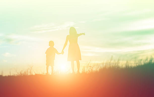 istock Mother encouraged her son outdoors at sunset, silhouette concept 543183596