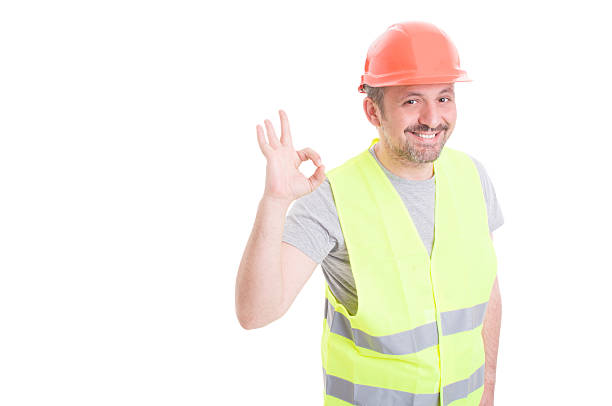 istock Joyful builder wearing vest and helmet showing ok 543183818