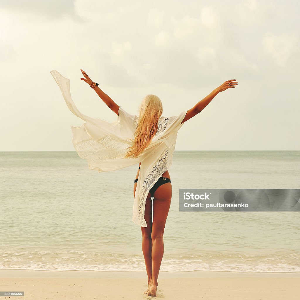 Woman enjoying nature at the beach. Arms wide open, freedom Happy woman enjoying nature at the beach. Arms wide open, freedom Beach Stock Photo