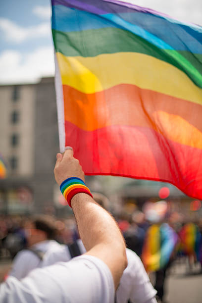 istock Rainbow gay pride flag and wristband in Pride Parade 543186462