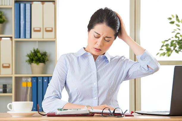 istock Young asian business woman with headache 543186548