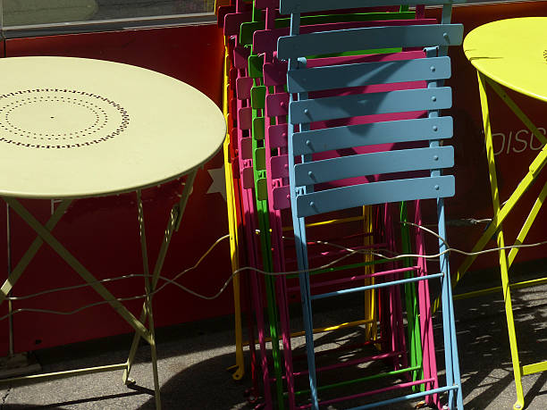 Colorful tables and chairs stacked on street Vienna Austria