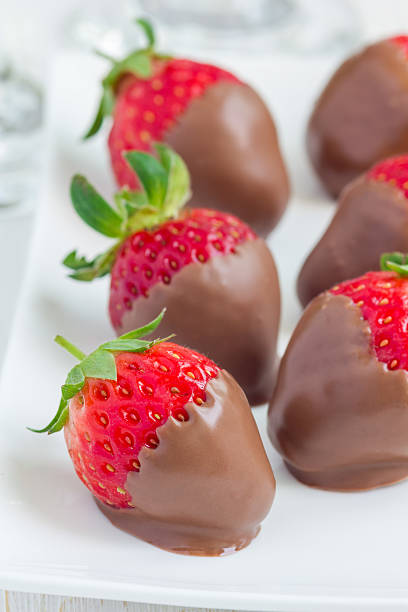 istock Strawberries covered with milk chocolate on a white plate 543191716