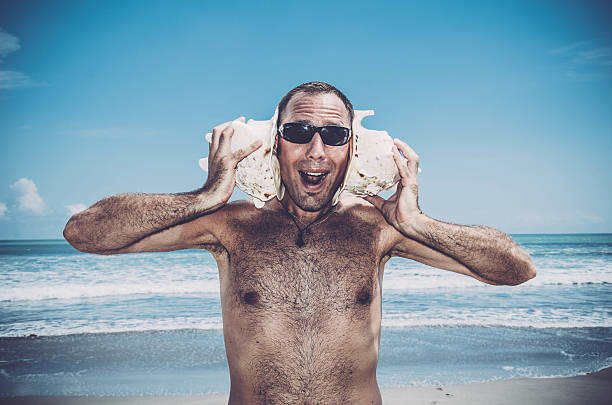 istock Funny Sea DJ  - Man with shells on his ears 543194096