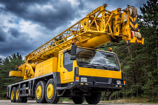 Yellow mobile crane in road construction