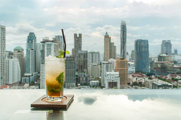 istock Mojito cocktail on table in rooftop bar with Bangkok city 543194674
