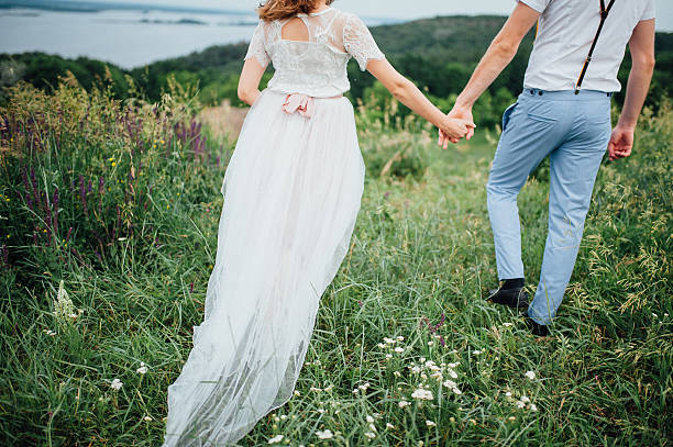 istock Happy Bride and groom walking on the green grass 543195706
