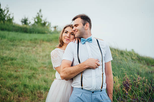 istock Happy Bride and groom walking on the green grass 543197202