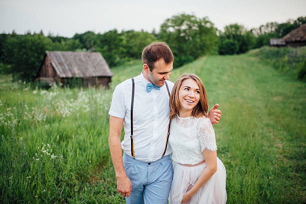 istock Happy Bride and groom walking on the green grass 543198696