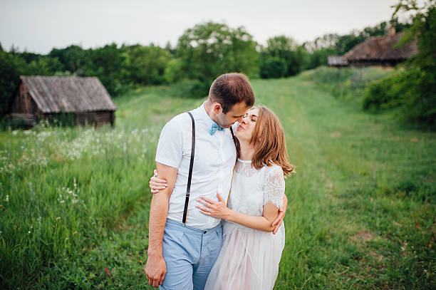 istock Happy Bride and groom walking on the green grass 543198720