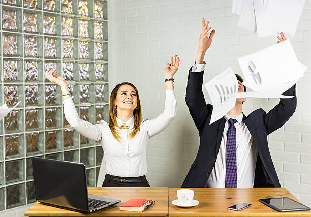 istock Cheerful workers throwing paper and smiling in the office 543201130