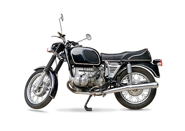 a black two-wheeled motorbike is presented on a white backdrop