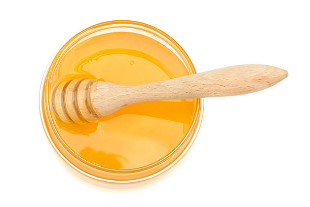 istock pot with honey and drizzler on a white background 543202144