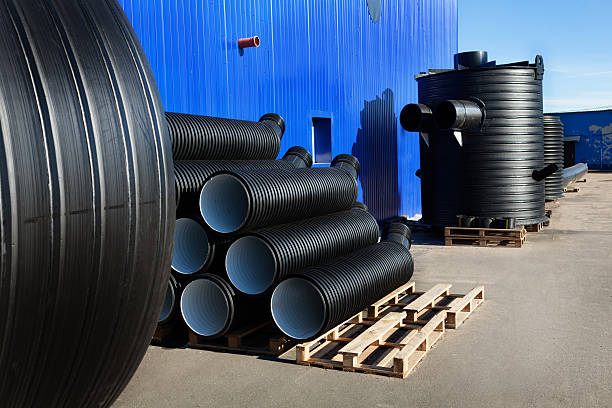 istock stacks of black pvc plastic pipe outdoors with fitting 543205116