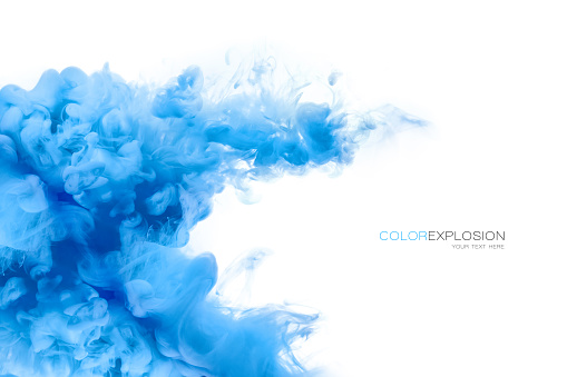 Closeup of a colorful blue acrylic ink in water isolated on white with copy space. Template design. Abstract background. Color explosion. Paint texture.