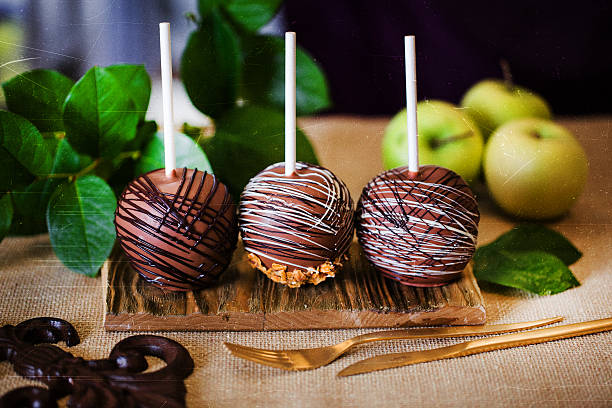 dessert, an apple dipped in chocolate on a stick stock photo
