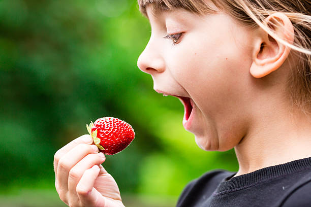 istock Girl eating fresh red strawberry 543210234