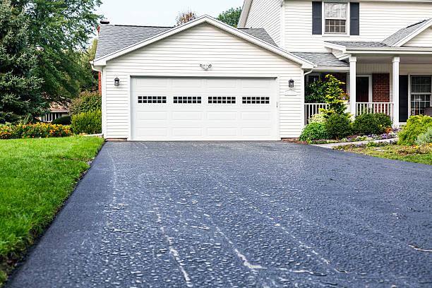New Asphalt Driveway Rain Puddles at Residential Home stock photo
