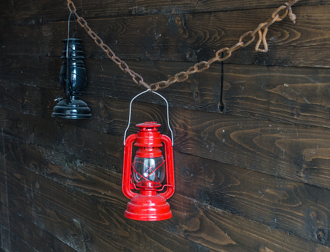 Two old oil lamp on a wooden wall