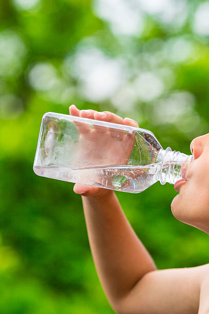 istock Child drinking clean tap water from transparent plastic bottle 543210634