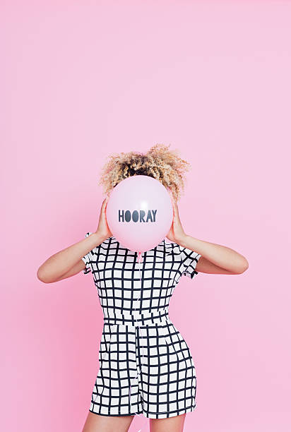 istock Young woman holding HOORAY balloon 543212854