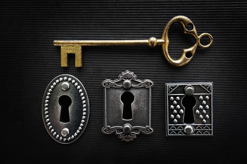 Three vintage door locks with gold key