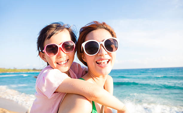istock Mother and Daughter having fun on the beach 543220618