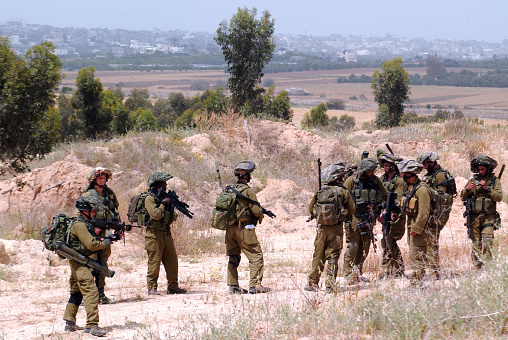 Beeri, Israel - April 16, 2008: Israeli infantry corps patrol in northern Gaza strip. The IDF is one of Israeli society's most prominent institutions, influencing the country's economy, culture and political scene.