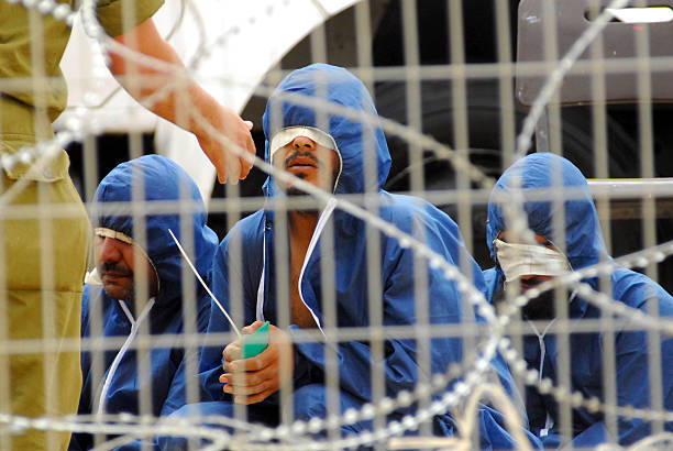 Palestinians prisoners Nir Oz, Israel - April 16, 2008: Palestinians prisoners are blindfolded and arrested. As of April 2013, there were approximately 4, 700 security prisoners in Israeli jails convicted of participating in terror attacks. gaza strip photos stock pictures, royalty-free photos & images