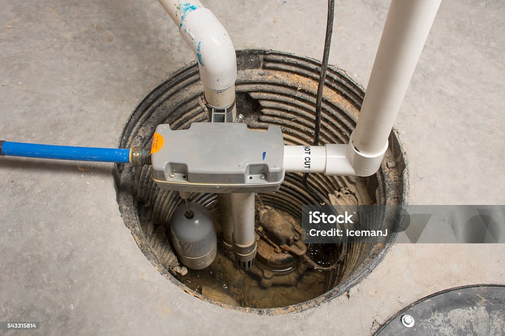 Backup Sump Pump A sump pump installed in a basement of a home with a water powered backup system. Water Pump Stock Photo