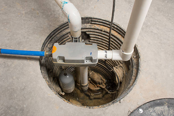 Backup Sump Pump A sump pump installed in a basement of a home with a water powered backup system. water pump stock pictures, royalty-free photos & images