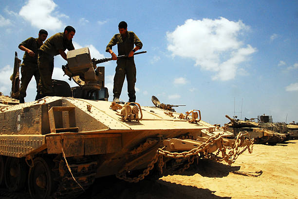 Israeli fighters in North Gaza strip Nirim, Israel - June 11, 2008: Israeli fighters maintain a M113 armored personnel carrier on in North Gaza strip. Under its disengagement plan in 2005, Israel retained exclusive control over Gaza strip. m2 machine gun photos stock pictures, royalty-free photos & images