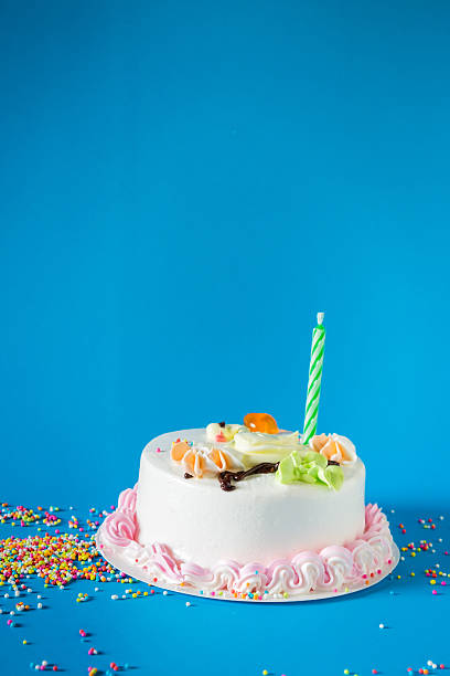 istock Birthday cake with candles on color background 543317462