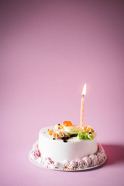 istock Birthday cake with candles on color background 543317512
