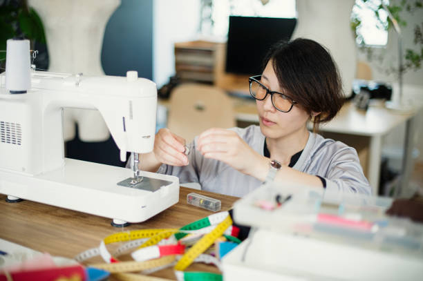 istock Young woman designer preparing a sewing machine 543318486