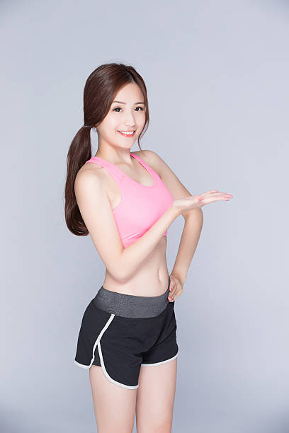 istock sport woman smiling showing something 543318908