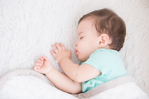 Newborn cute baby sleeping. Closeup portrait, caucasian child