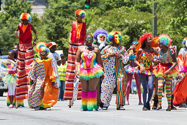 persone indossano costumi pagliaccio a piedi nella cultura caraibica parata - atlanta pride foto e immagini stock