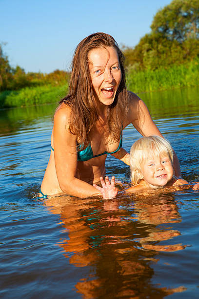 istock Mother with baby in the water 543323822