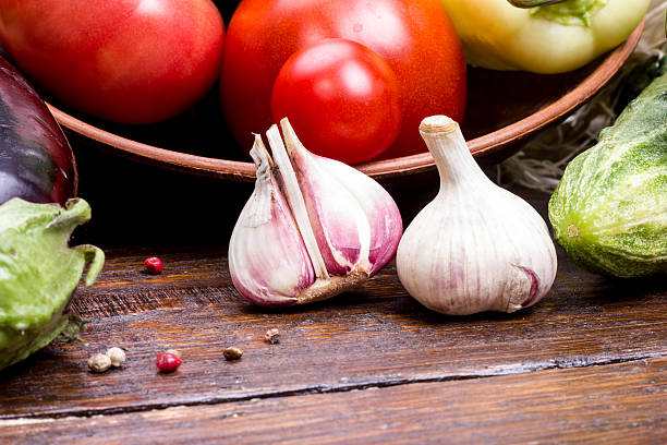 istock Garlic with vegetables on a wooden table 543327412