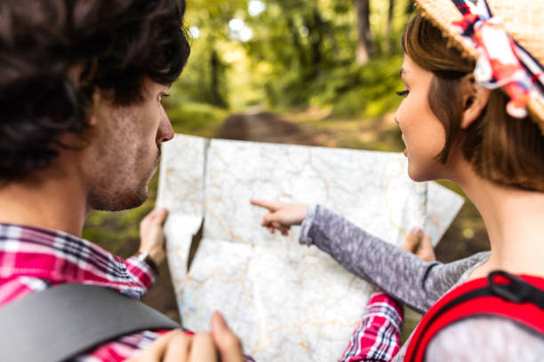 istock Close-up of couple looking for direction on map in nature. 543328904